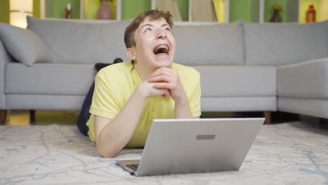 Young-man-watching-funny-videos-on-laptop-at-home.